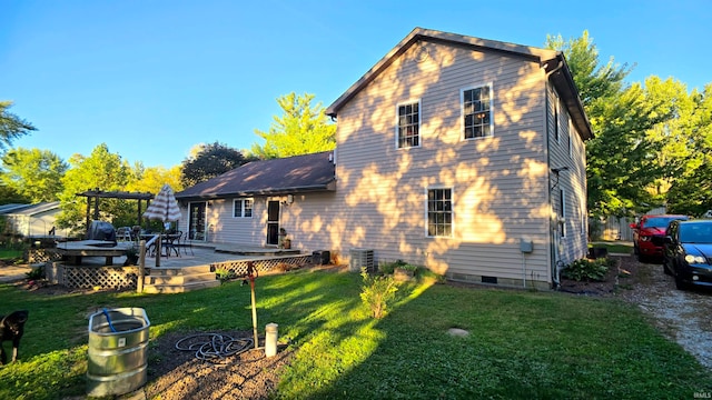 back of house with a wooden deck, cooling unit, and a yard