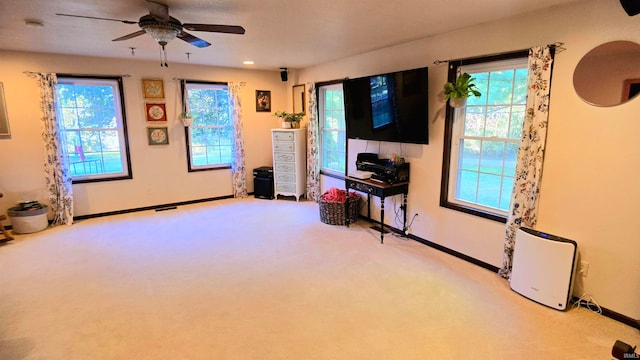 living room featuring ceiling fan and light carpet