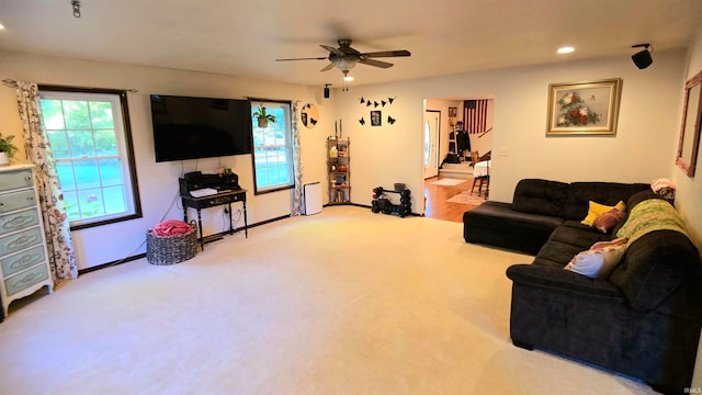 carpeted living room featuring ceiling fan