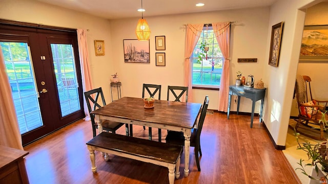 dining space with wood-type flooring and french doors