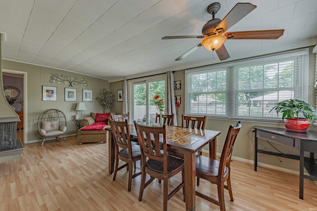 dining area with ceiling fan, light wood-type flooring, and a wealth of natural light