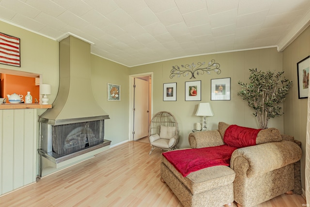 living room featuring hardwood / wood-style floors and ornamental molding