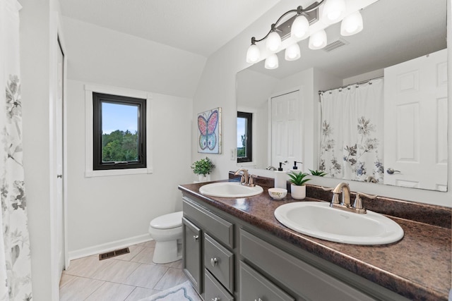 bathroom with tile patterned flooring, lofted ceiling, a shower with curtain, vanity, and toilet