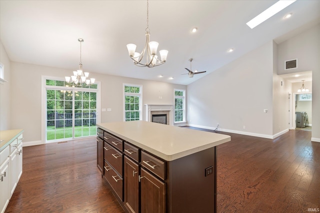 kitchen featuring a glass covered fireplace, plenty of natural light, visible vents, and light countertops