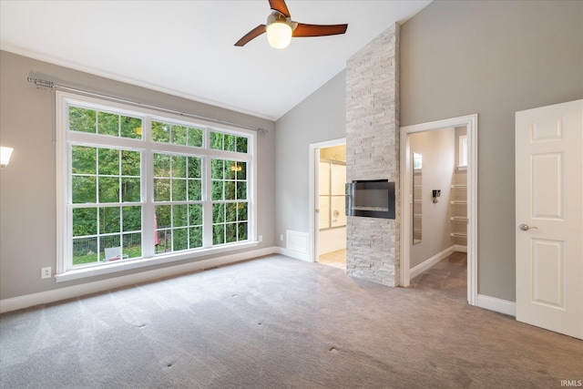 unfurnished living room featuring high vaulted ceiling, ceiling fan, a fireplace, carpet flooring, and baseboards