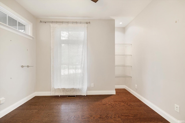 unfurnished room with baseboards and wood finished floors