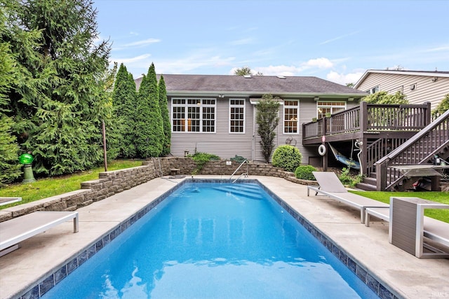 pool featuring stairway, a deck, and a patio