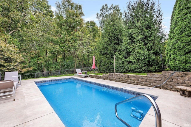 view of swimming pool featuring a patio, a fenced in pool, and fence