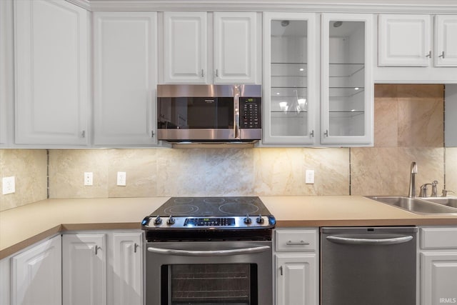 kitchen with a sink, white cabinetry, and stainless steel appliances