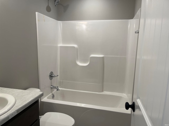 full bathroom with vanity, washtub / shower combination, and toilet