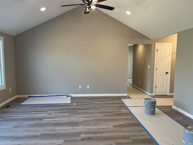 spare room featuring wood-type flooring and lofted ceiling