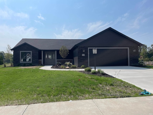 ranch-style home featuring a garage and a front lawn