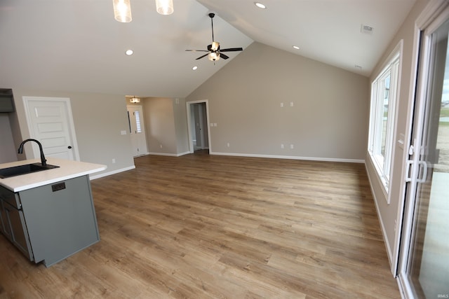 kitchen featuring wood-type flooring, a center island with sink, sink, and ceiling fan