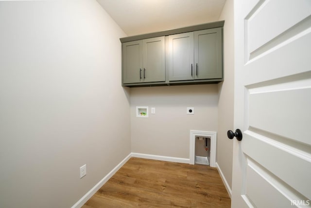 clothes washing area featuring cabinets, washer hookup, electric dryer hookup, and hardwood / wood-style flooring