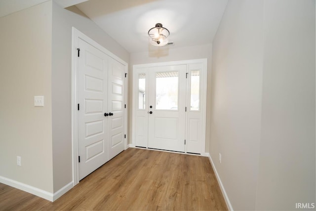 foyer entrance with light hardwood / wood-style flooring