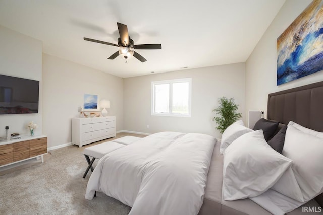 bedroom with ceiling fan and light carpet