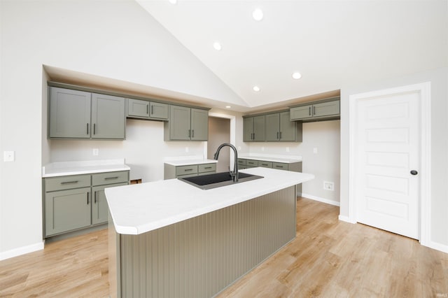 926 Lagonda Trl, Fort Wayne, IN 46818 - kitchen featuring a sink, an island with sink, recessed lighting, light wood-style floors, and baseboards