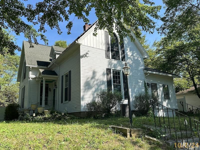 631 Williamson St, Rockport, IN 47635 - view of property exterior featuring a chimney, fence, and a yard