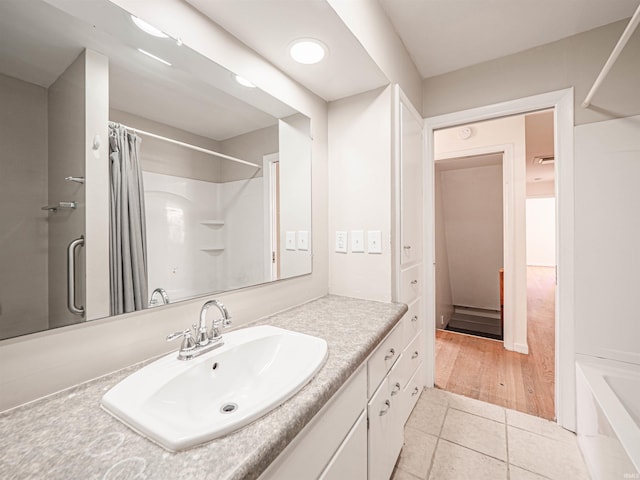 bathroom with wood-type flooring, vanity, and shower / bath combo with shower curtain