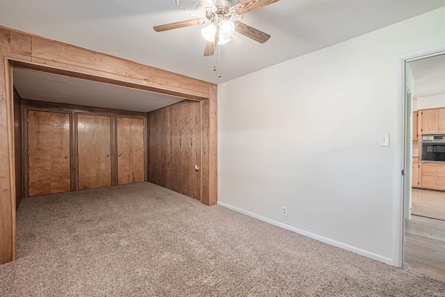 unfurnished bedroom featuring light carpet and ceiling fan