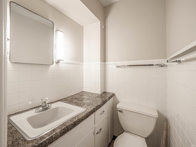 bathroom featuring tile walls, vanity, and toilet