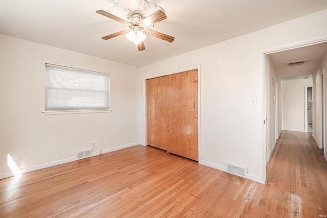 unfurnished bedroom with light hardwood / wood-style floors, ceiling fan, and a closet