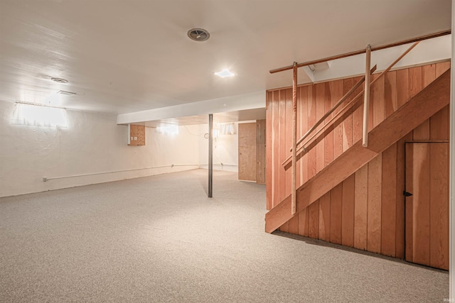 basement featuring light colored carpet