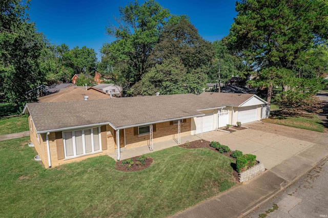 ranch-style house featuring a garage and a front yard