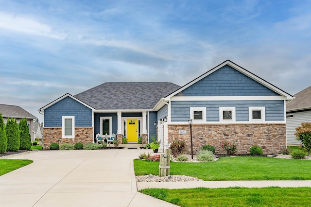 craftsman-style house with a porch and a front lawn