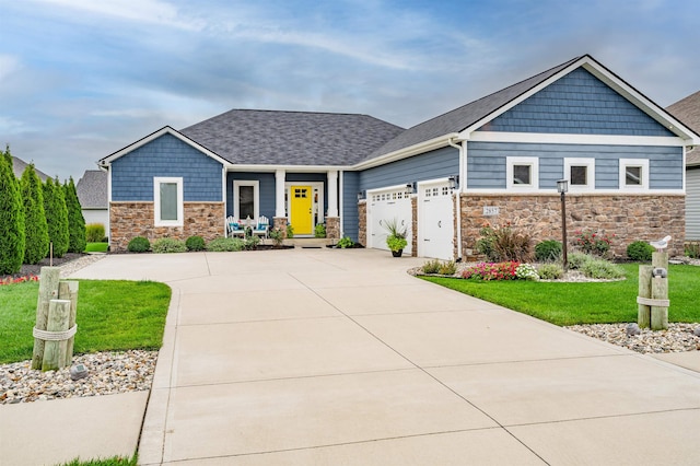 craftsman-style home with a front lawn and a garage