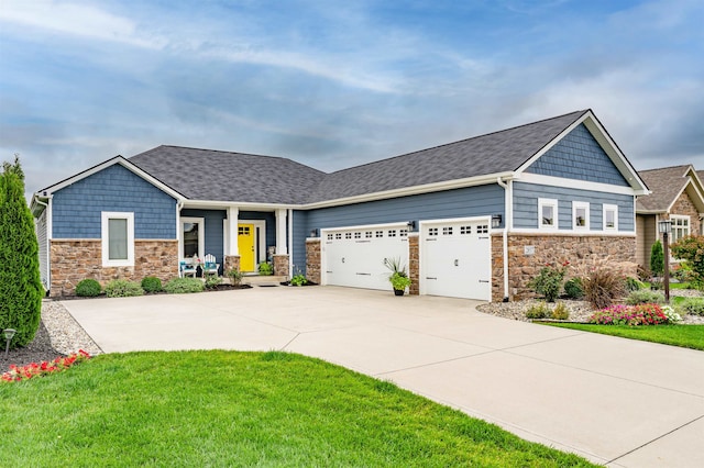 craftsman-style house featuring a garage and a front lawn