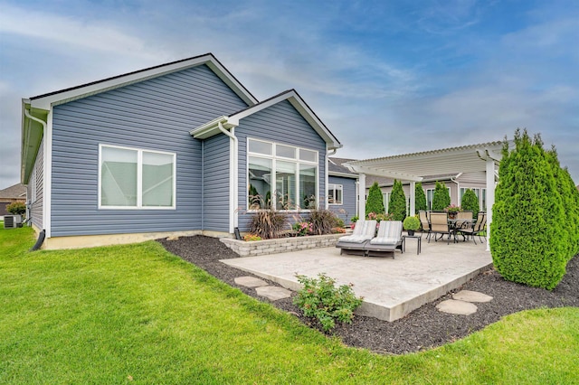 rear view of property featuring cooling unit, a yard, a pergola, and a patio area