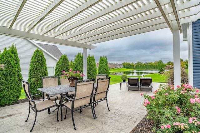 view of patio with a water view and a pergola