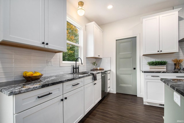 kitchen with dishwasher, tasteful backsplash, sink, white cabinets, and dark hardwood / wood-style flooring