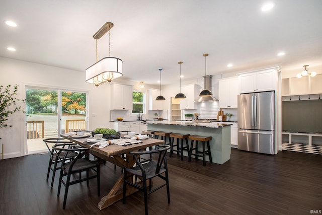 dining area with an inviting chandelier, dark hardwood / wood-style floors, sink, and plenty of natural light