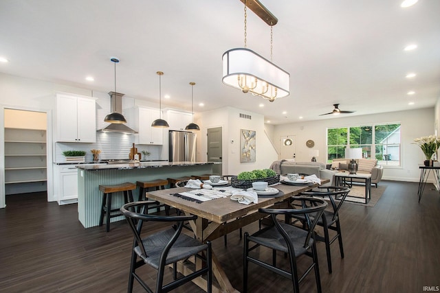 dining room featuring ceiling fan and dark hardwood / wood-style floors