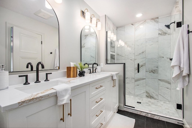 bathroom with walk in shower, vanity, and tile patterned flooring