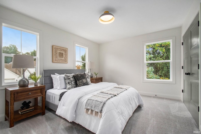 carpeted bedroom featuring multiple windows