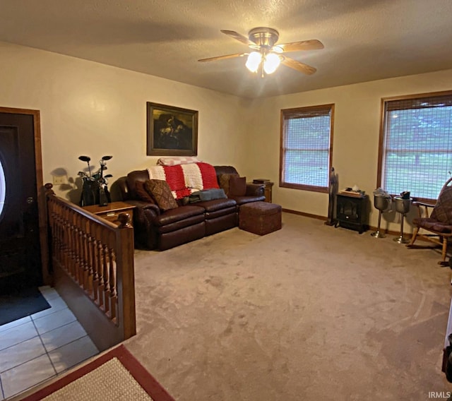 carpeted living room featuring a textured ceiling and ceiling fan