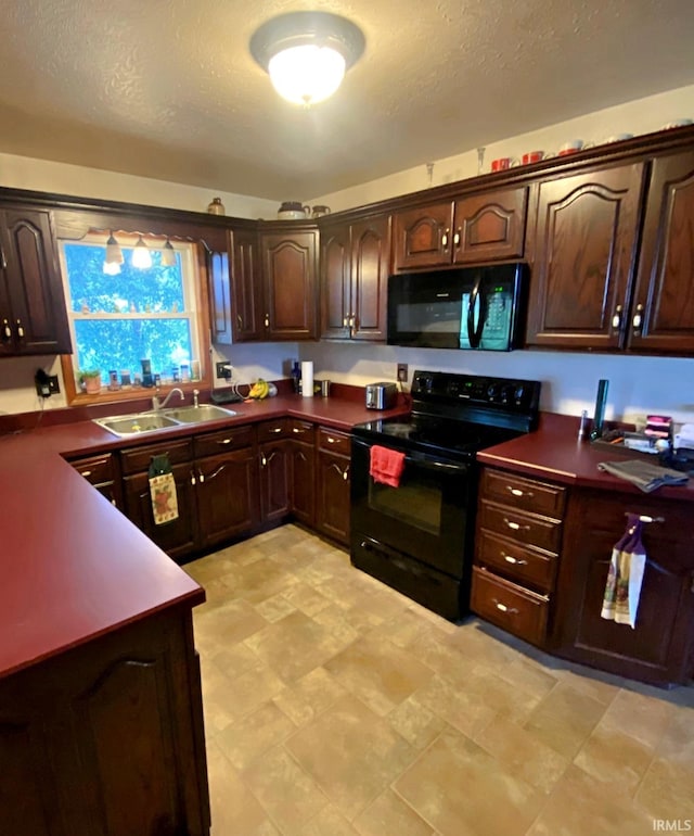 kitchen featuring a textured ceiling, black appliances, dark brown cabinets, and sink