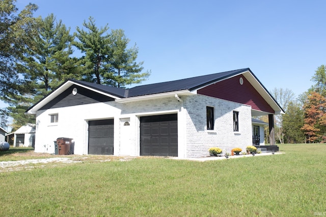 view of side of home with a garage and a yard