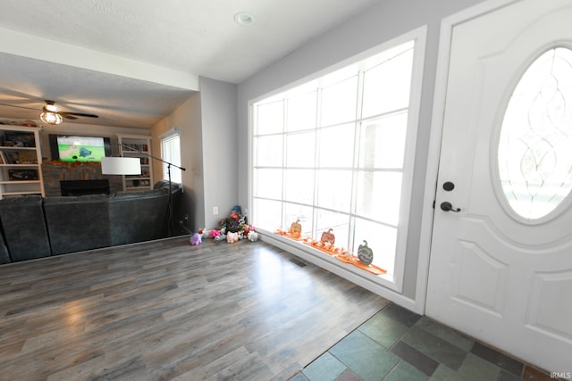 entryway featuring ceiling fan, a textured ceiling, and dark hardwood / wood-style floors