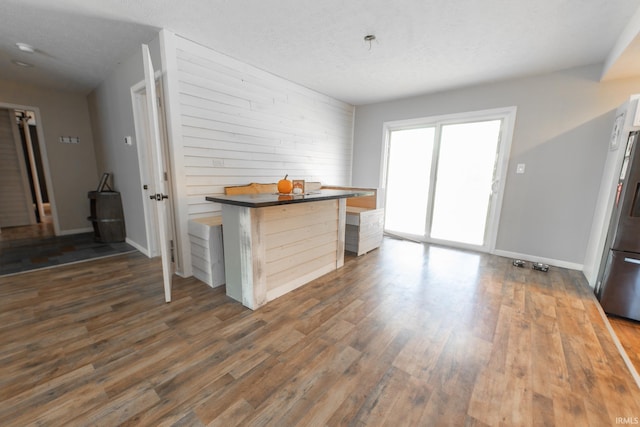 interior space featuring a textured ceiling and dark hardwood / wood-style floors