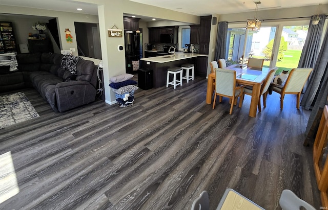 dining area with dark hardwood / wood-style flooring and sink