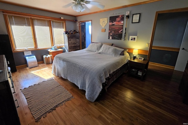 bedroom featuring hardwood / wood-style flooring, ceiling fan, and ornamental molding