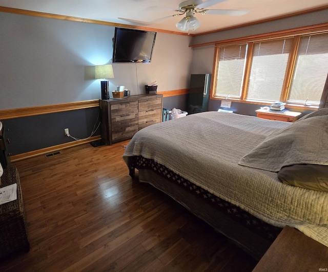 bedroom with ceiling fan, dark hardwood / wood-style flooring, and ornamental molding