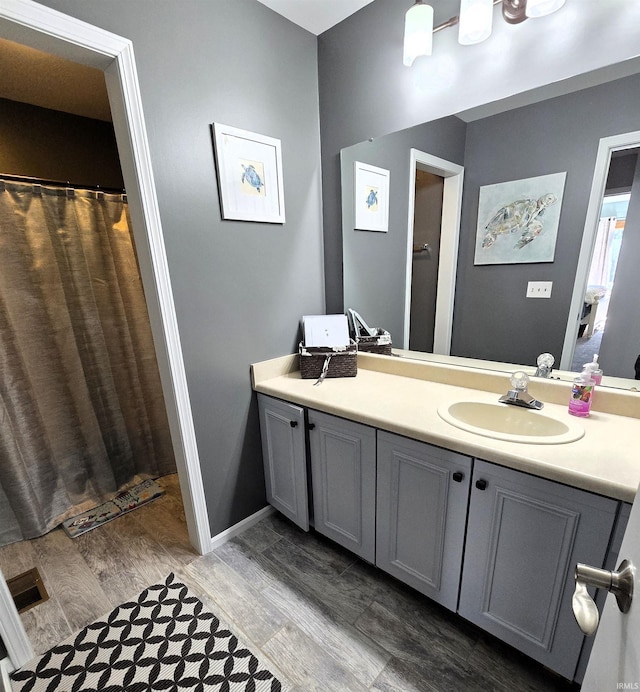 bathroom with hardwood / wood-style floors and vanity