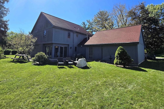 rear view of property with an outdoor hangout area and a lawn