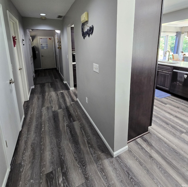 hallway with dark hardwood / wood-style flooring and sink