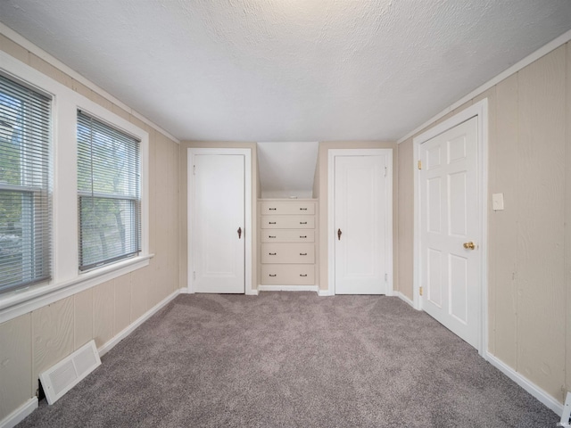 unfurnished bedroom featuring a textured ceiling and carpet flooring